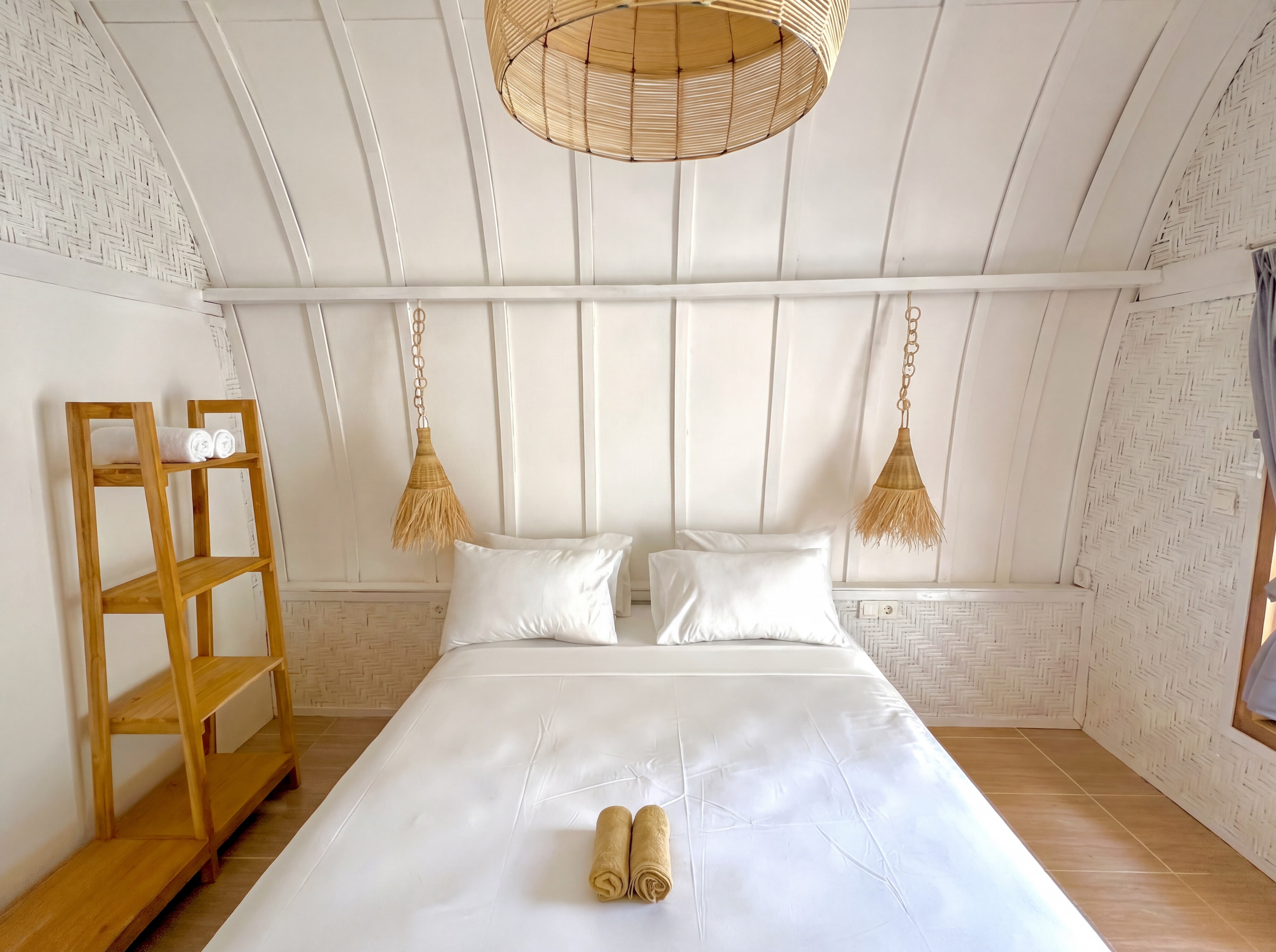 Bedroom with woven pendant lights under arched ceiling