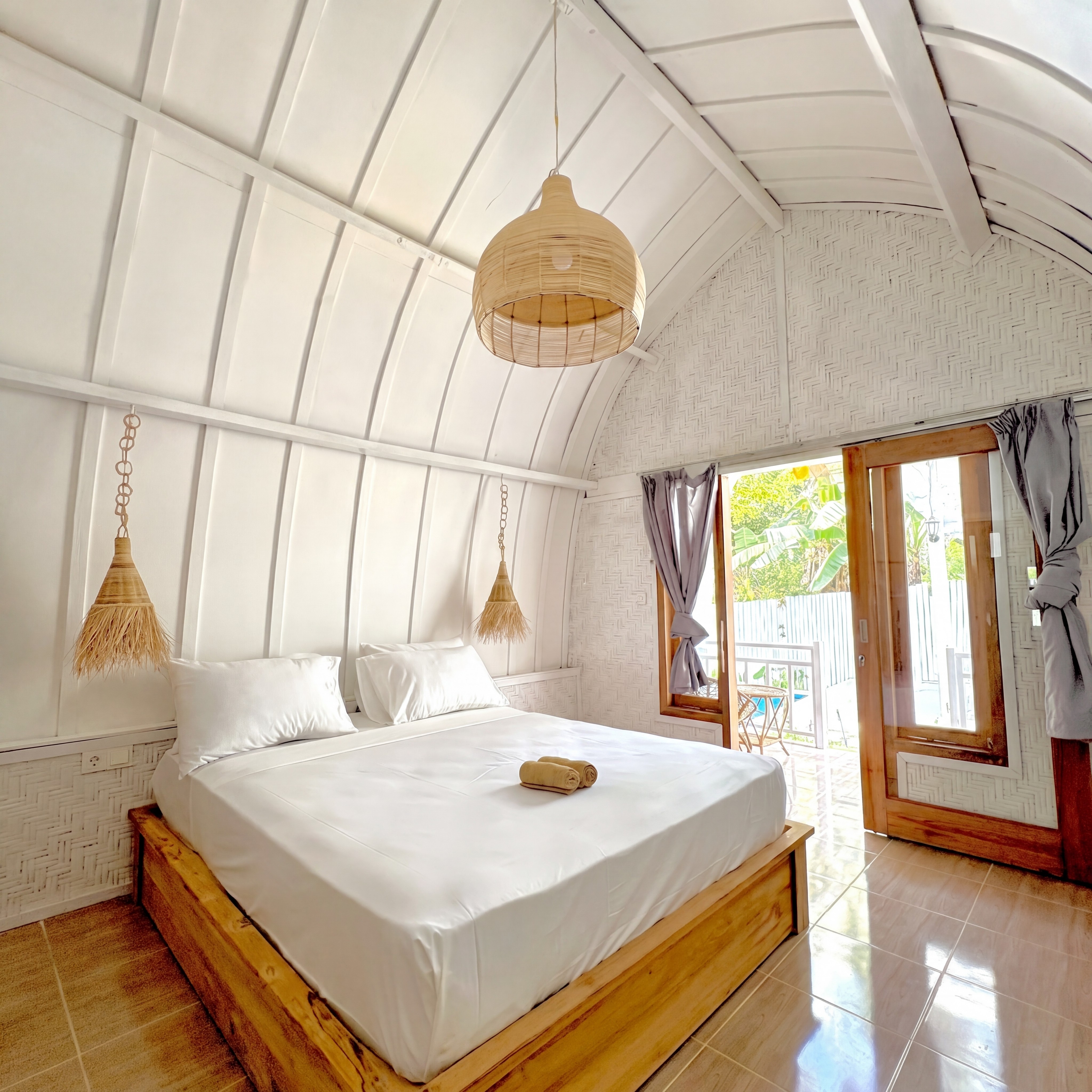 Master bedroom with terrace doors and wooden beams