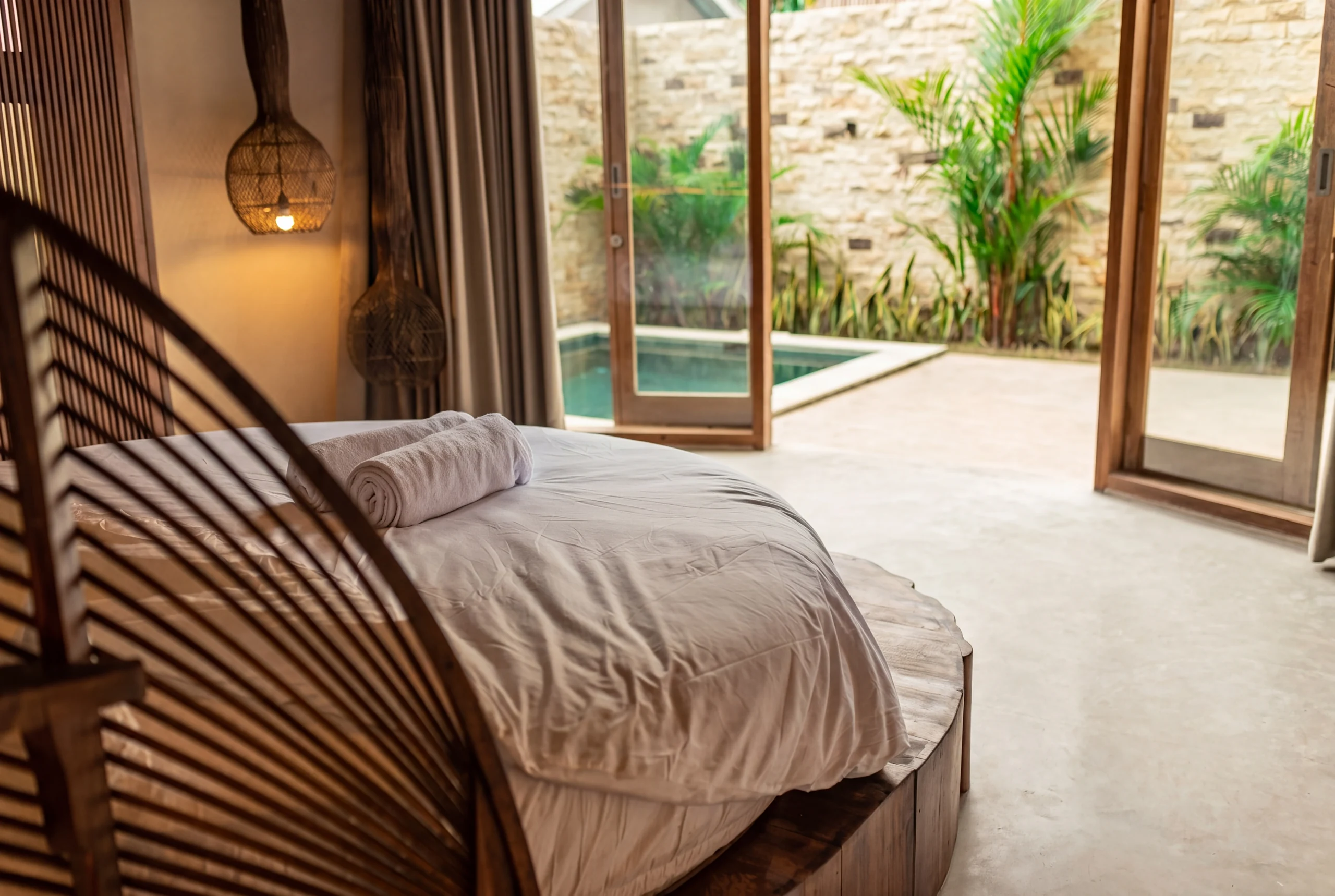 Bedroom with wooden accent wall and garden access
