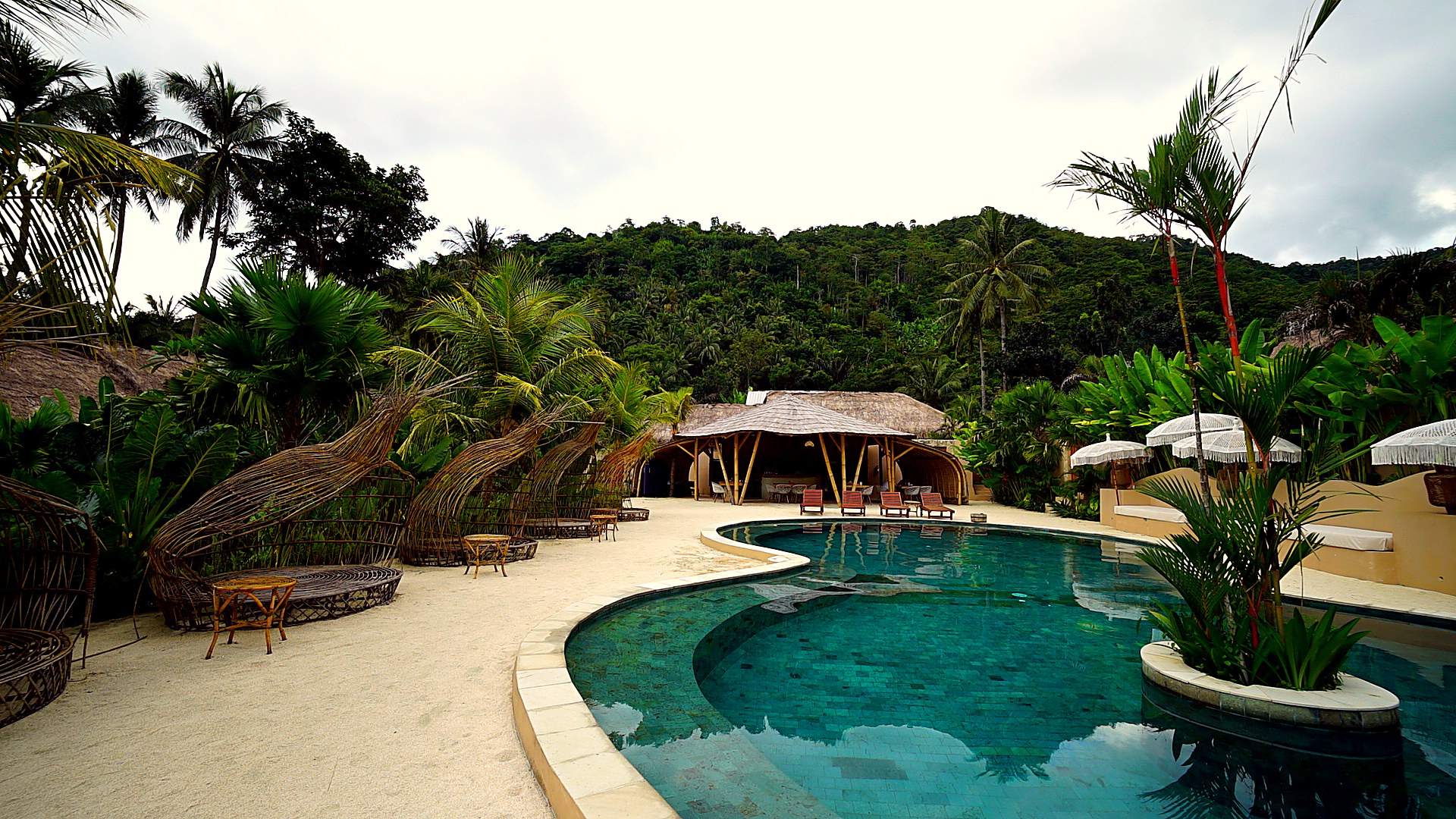 Resort pool and bamboo gazebo at daytime