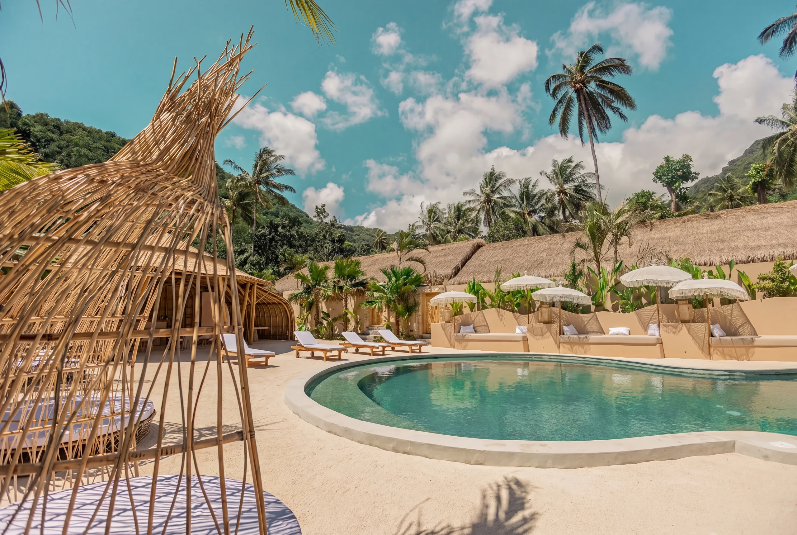 Pool area with bamboo gazebo and palm trees