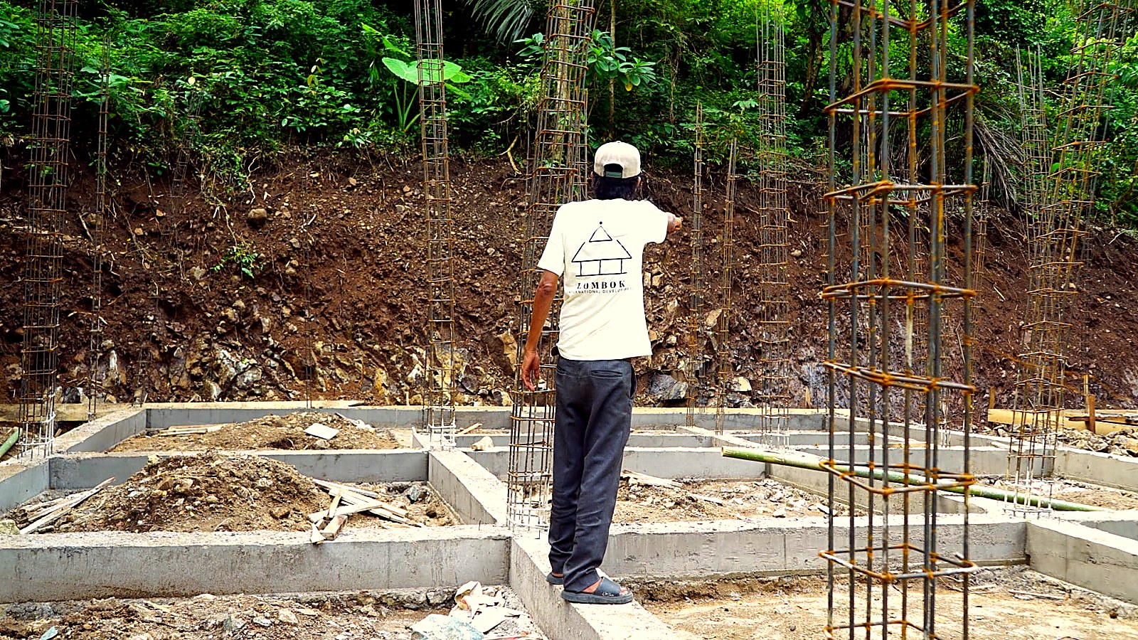 Site supervisor checking steel rebar cages before pouring concrete