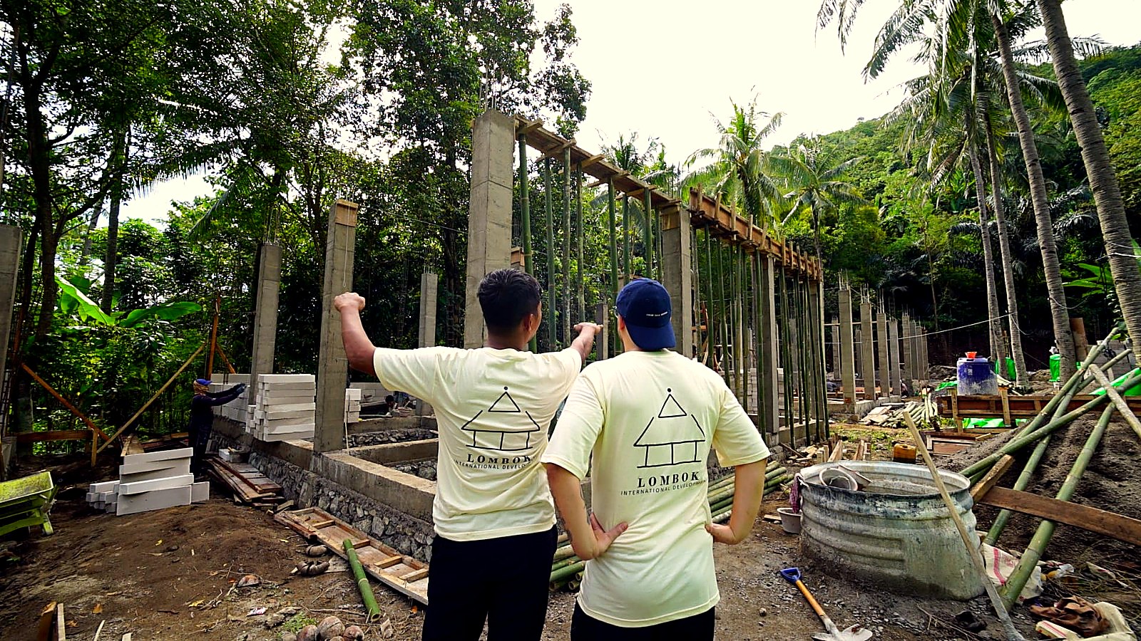 Two crew members from behind reviewing the column and formwork structure